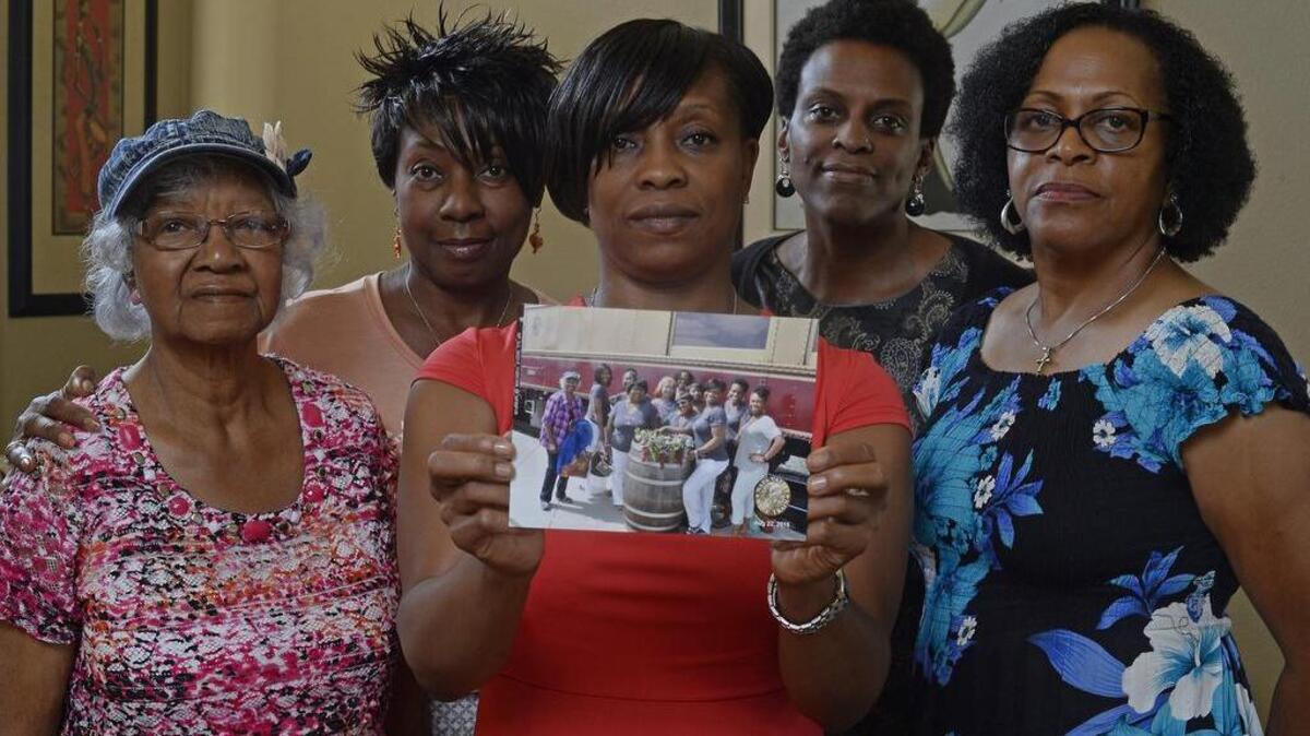 
From left, Katherine Neal, Georgia Lewis, Lisa Renee Johnson, Allisa Carr and Sandra Jamerson, members of the Sistahs on the Reading Edge book club, all of Antioch, Calif., stand together at Johnson's home in Antioch on Monday. The five were among 11 women, 10 of whom are black, booted off the Napa Valley Wine Train. Johnson holds a photograph of the group that was taken before boarding the train. 
