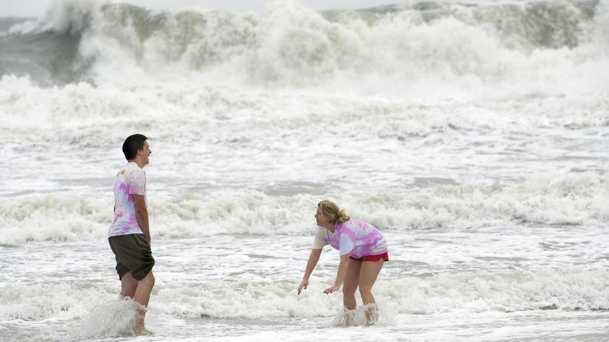 Steve Kester, 21, left and Alexis Sirnie, 20, both of Pittsburg, Pa, play in the surf in Ocean City, Md., Saturday, Oct. 3, 2015.