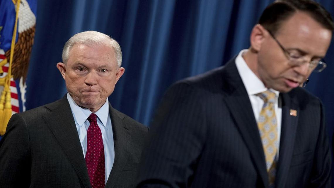 Deputy Attorney General Rod Rosenstein, right, accompanied by Attorney General Jeff Sessions, left, speaks at a news conference to announce an international cybercrime enforcement action at the Department of Justice, Thursday, July 20, 2017, in Washington.