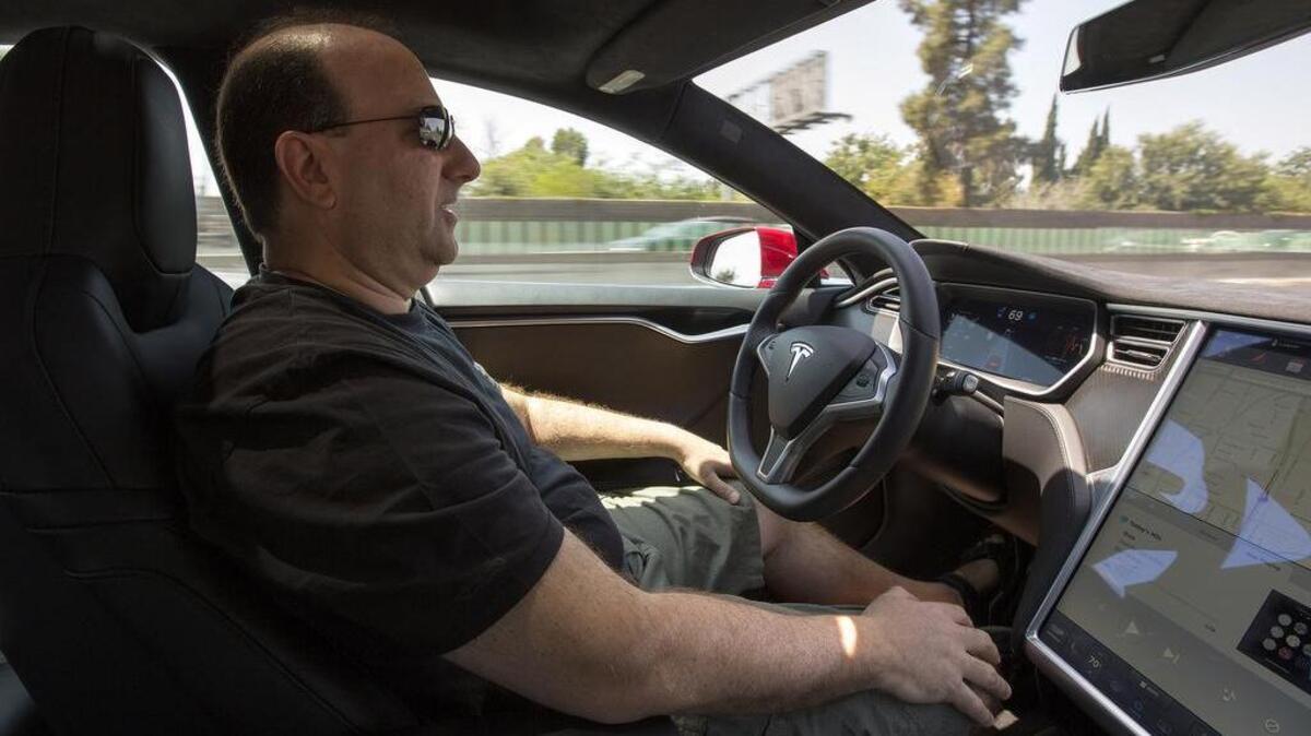 Jason Fudenberg, the president of the Los Angeles Tesla Club, drives using autopilot on the 101 freeway near Sherman Oaks, Calif.