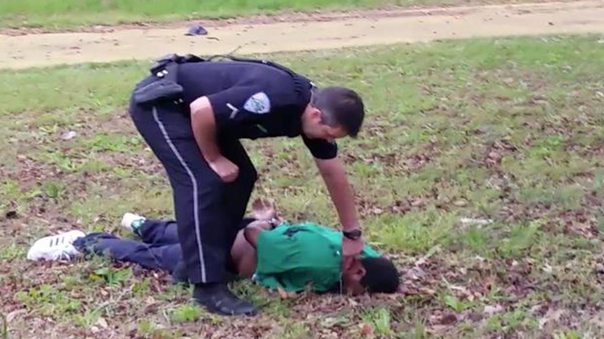 
In this frame from a video taken April 4, 2015, patrolman Michael Thomas Slager checks Walter Scott’s pulse in North Charleston, S.C. Little is known about the young man who recorded the chilling images on his Samsung cellphone. An attorney for the Scott family has said that the young man is afraid he will face retribution and has declined to publicly disclose his name, age or race.
