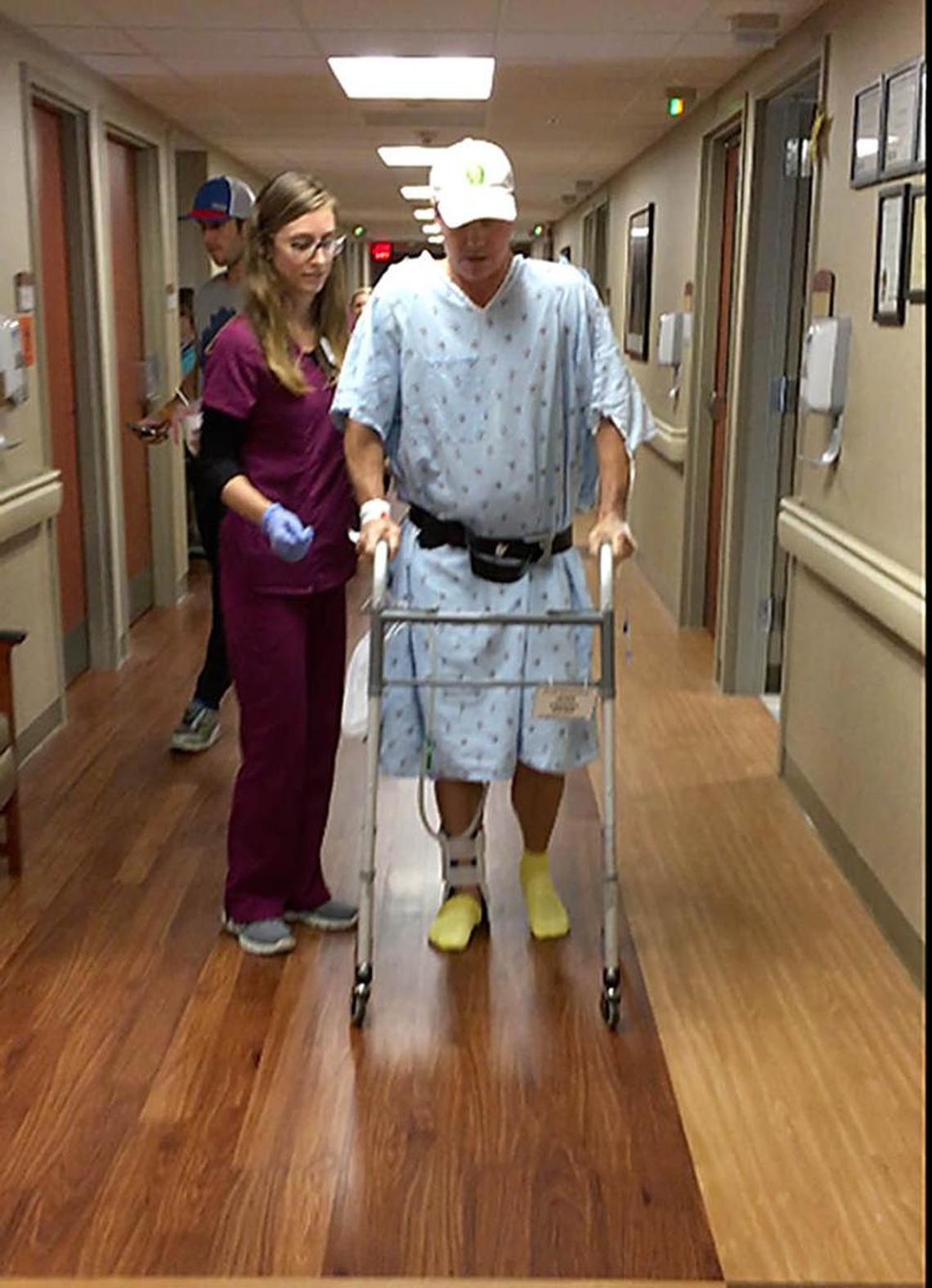 Dean Otto walks with assistance down a hallway in Carolinas Medical Center just a few days after the Sept. 24, 2016, accident. The first steps he took with that walker, he says – about 72 hours post-surgery – “were the most painful two steps I’ve ever taken.”