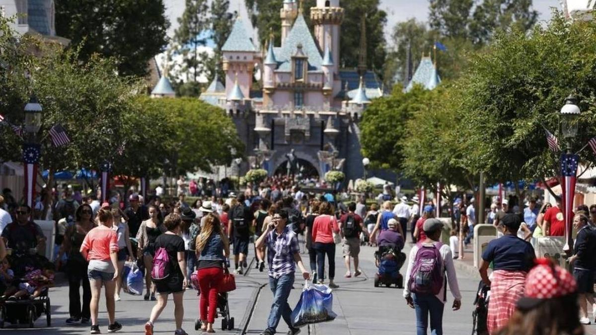 Patrons walk along Main Street in Disneyland on May 20, 2014, in Anaheim.