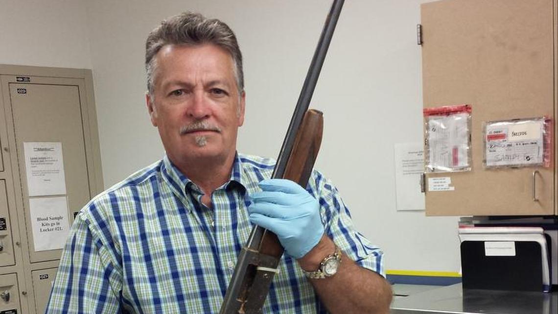 Detective Michael Ciesynski holds the shotgun which rock legend Kurt Cobain used to kill himself on April 8, 1994, in a photo released Thursday by Seattle police. Police did not say why they took the photos last year or why they’re releasing them to the public at this time.