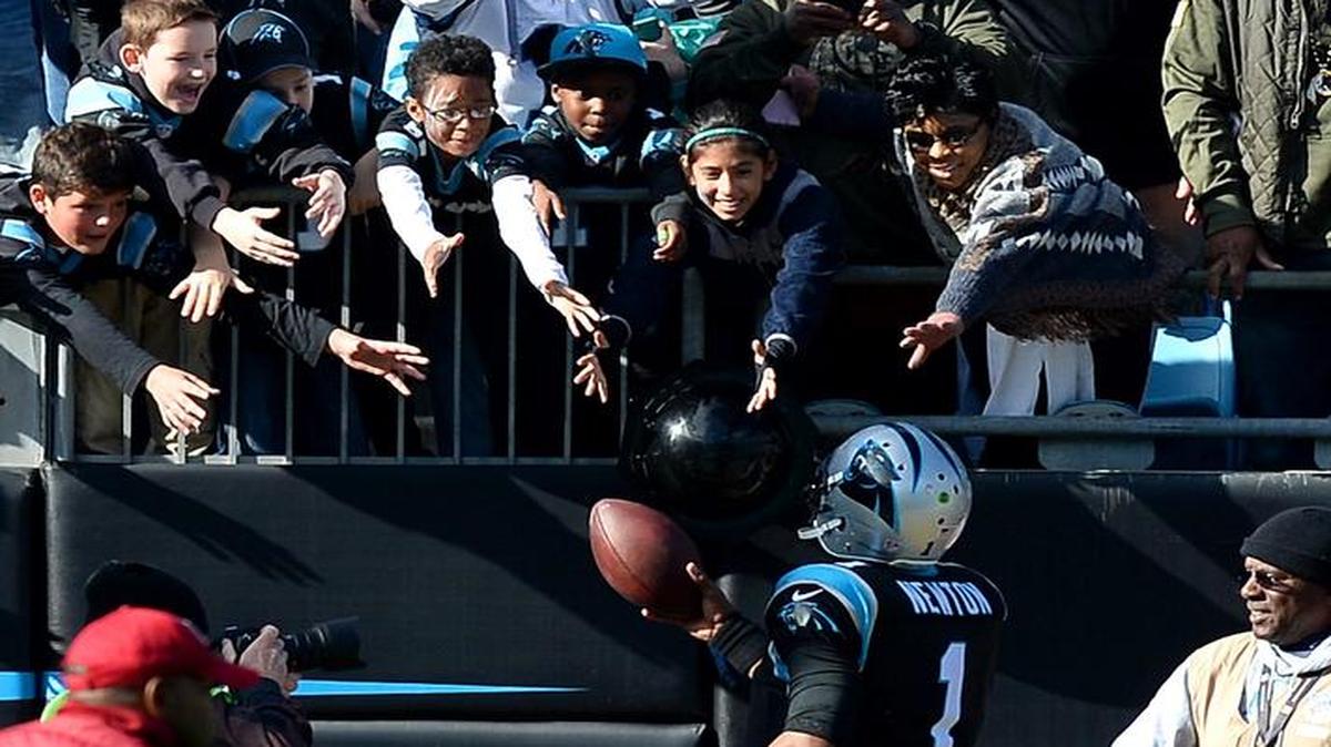 Carolina Panthers fans anxiously wait for quarterback Cam Newton to deliver a touchdown football to the stands during second quarter action at Bank of America Stadium in Charlotte, NC on Sunday, November 22, 2015.
