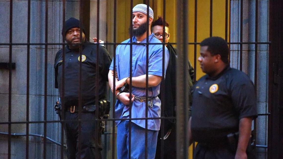 “Serial” podcast subject Adnan Syed is escorted from the courthouse after the first day of hearings for a retrial in Baltimore on Wednesday, Feb. 3, 2016.
