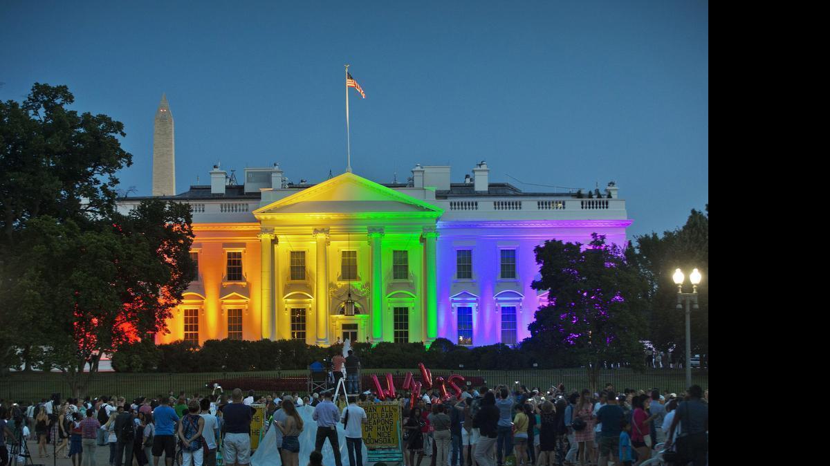 
People gathered in Lafayette Park to see the White House illuminated on Friday, June 26, 2015, with rainbow colors in commemoration of the Supreme Court's ruling to legalize same-sex marriage.
