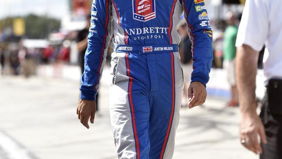 
Justin Wilson of England walks down pit road during qualifying for Sunday’s Pocono IndyCar 500 auto race Saturday in Long Pond, Pa. Wilson, 37, suffered head injuries in that race and died Monday.
