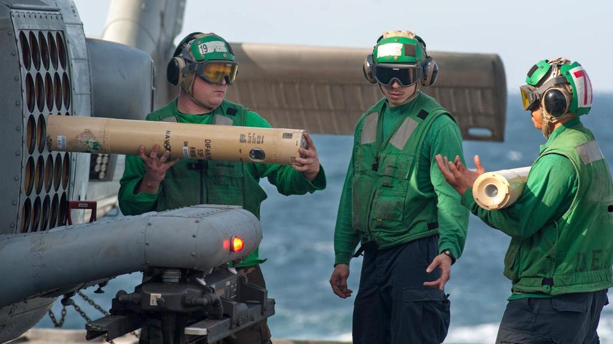 Sailors unload sonar-emitting buoys from an MH-60R Sea Hawk helicopter aboard the guided-missile cruiser USS Mobile Bay in the Arabian Sea in 2012. The Navy was given permission to use low-frequency sonar for training, testing and routine operations, but the 9th Circuit Court of Appeals in San Francisco ruled Friday that it should not have been allowed to do so.