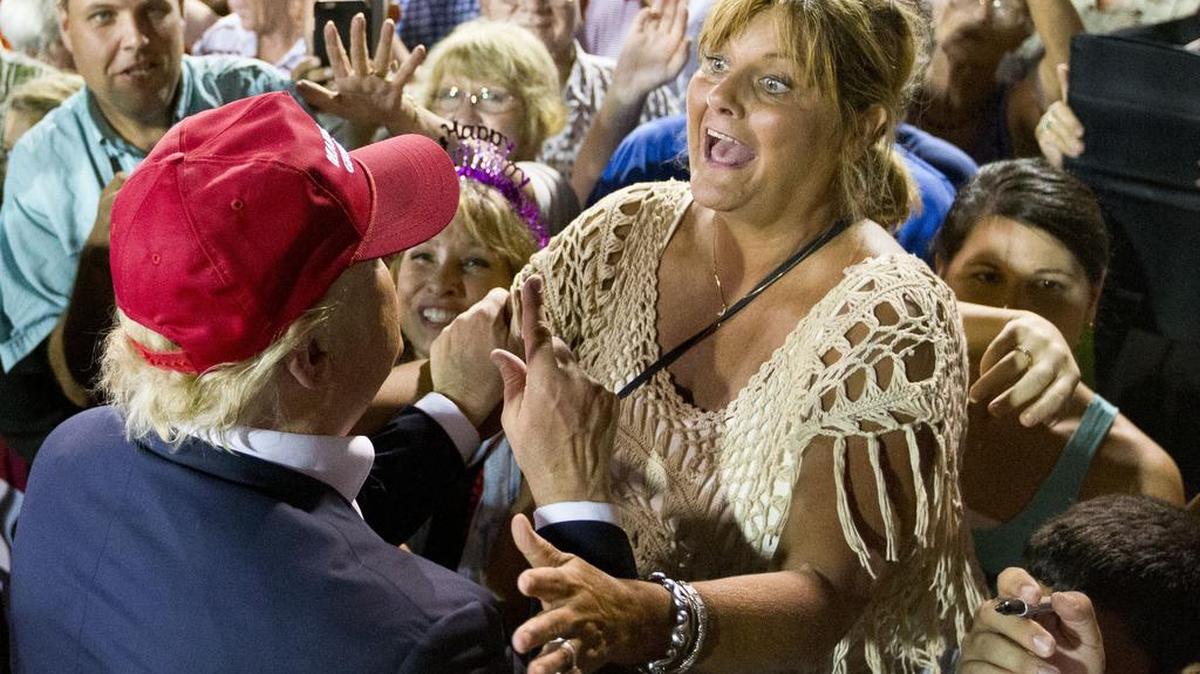 
A woman shows excitement when meeting Republican presidential candidate businessman Donald Trump during a campaign rally Friday in Mobile, Ala. 
