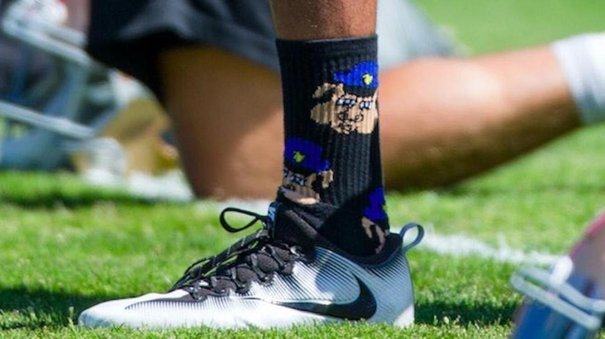 Photos have surfaced of 49ers quarterback Colin Kaepernick wearing socks that appear to depict pigs wearing police hats to football practice in early August.