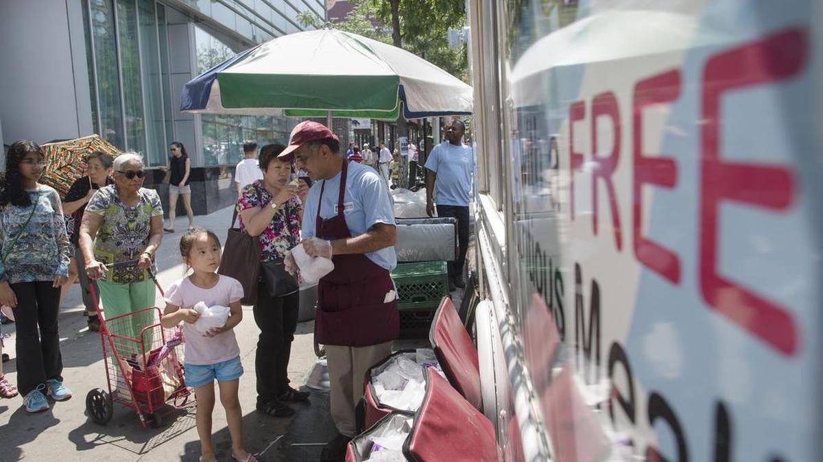 Kids receive free lunches at the Get Ready 2 Go truck in the Flushing neighborhood of the Queens borough of New York.