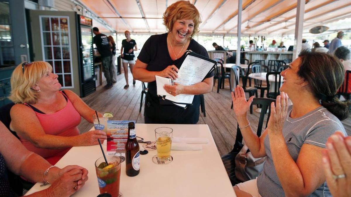 Ann LePage chats with diners after taking their order at McSeagull’s restaurant, Thursday, June 23, 2016, in Boothbay Harbor. The wife of America’s lowest-paid governor has taken a summer waitressing job and is saving for a car.