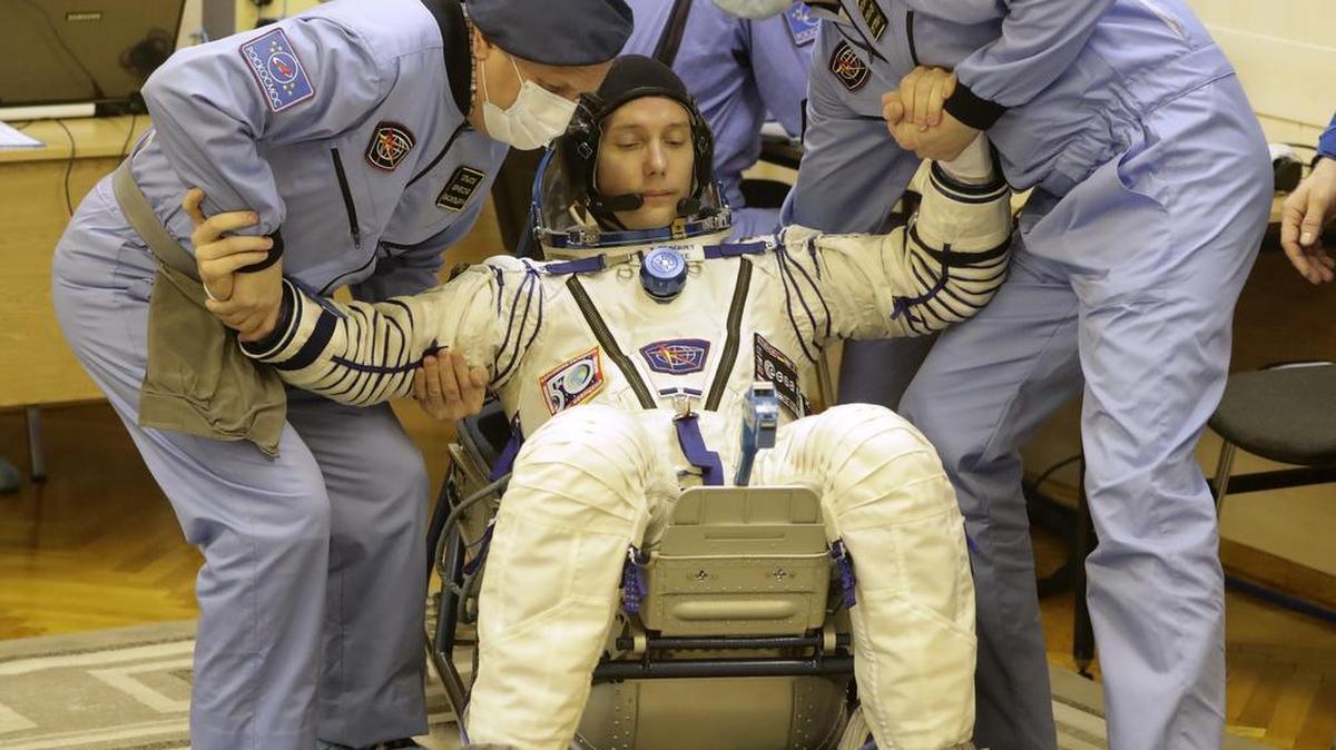 Russian Space Agency experts help French astronaut Thomas Pesquet, member of the main crew to the International Space Station (ISS), to stand up after inspecting his space suit prior the launch of Soyuz-FG rocket at the Russian leased Baikonur cosmodrome, Kazakhstan, Thursday, Nov. 17, 2016.