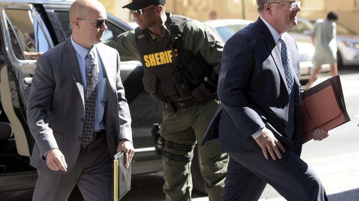 Lt. Brian Rice, left, one of the six members of the Baltimore Police Department charged in connection with the death of Freddie Gray, arrives with attorney Mike Davey, right, at a courthouse to hear a judge's ruling in his trial in Baltimore, Monday, July 18, 2016.