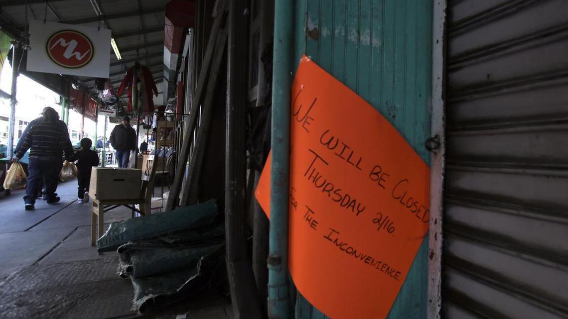 A sign hangs outside the closed Marco's Fish Market Thursday Feb, 16, 2017 in south Philadelphia's Italian Market. In an action called "A Day Without Immigrants", immigrants across the country stayed home from school and work on Thursday to show how critical they are to the U.S. economy and way of life.