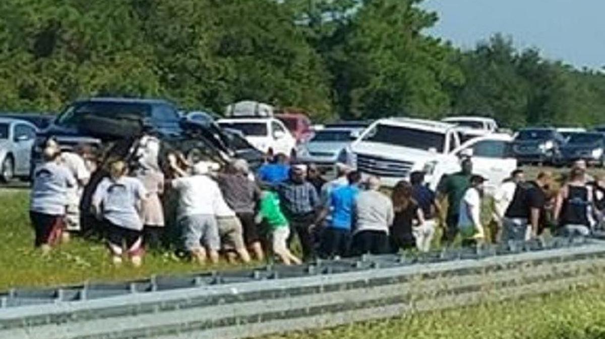 Dozens of strangers came together Saturday morning to help after a crash on I-75. They were able to get the 31-year-old driver and a young passenger out of a vehicle that flipped over.