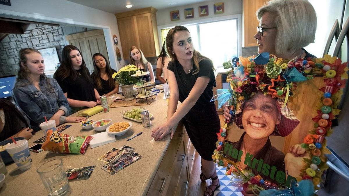 Modesto Girl Scout Troop 3380 leader Joanne Serpa, right, holds a large picture of Kristen Machado as she, Claire Machado, middle, and other members of the troop share memories of their former troop leader during a gathering at Serpa’s home in Modesto, Calif., on Tuesday, July 26, 2016. Kristen Machado formed the troop in 2003 and led it for nine years. Seven of those, she also battled sarcoma cancer – a fight she lost Oct. 29, 2012, less than two weeks before her 40th birthday.