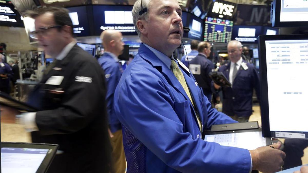 
Trader James Lamb, center, works on the floor of the New York Stock Exchange Thursday, Aug. 27, 2015. 
