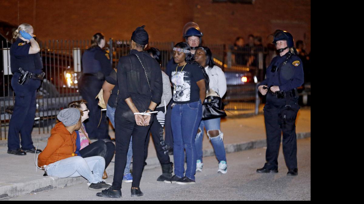 
Protesters wait to be transported after getting arrested after protesting the acquittal of Cleveland police officer Michael Brelo on May 23, 2015, in Cleveland. The acquittal came at a time of nationwide tension among police and black citizens punctuated by protests over the deaths of black suspects at the hands of white officers — and following a determination by the U.S. Department of Justice that Cleveland police had a history of using excessive force and violating civil rights.
