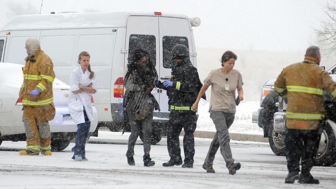 People are escorted away after a deadly shooting at a Planned Parenthood clinic Nov. 27, 2015, in Colorado Springs, Colo.