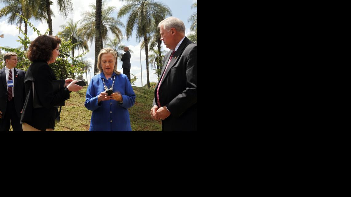 
Then-U.S. Secretary of State Hillary Rodham Clinton, center, types on her cell phone with Roberta S. Jacobson, U.S. Assistant Secretary of State for Western Hemisphere Affairs, left, and U.S. Ambassador to Brazil Thomas Shannon in Brasilia, Brazil, before heading to Brussels on April 17, 2012. 
