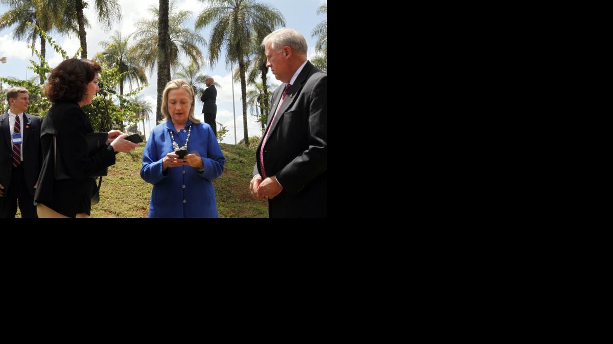 
Then-U.S. Secretary of State Hillary Rodham Clinton, center, types on her cell phone with Roberta S. Jacobson, U.S. Assistant Secretary of State for Western Hemisphere Affairs, left, and U.S. Ambassador to Brazil Thomas Shannon in Brasilia, Brazil, before heading to Brussels on April 17, 2012. 

