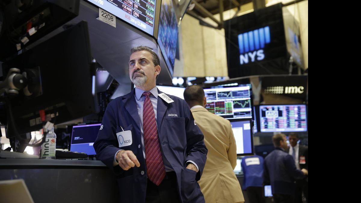 
Traders work on the floor at the New York Stock Exchange in New York, Wednesday, July 8, 2015. Later in the morning, technical issues brought trading to a standstill on the floor of the NYSE.
