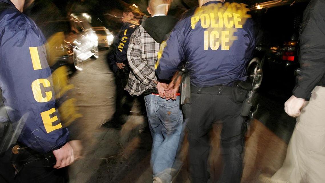 Immigration and Customs Enforcement (ICE) officers arrest a suspect during a pre-dawn raid in Santa Ana, Calif., in this file photo from Wednesday, Jan. 17, 2007.