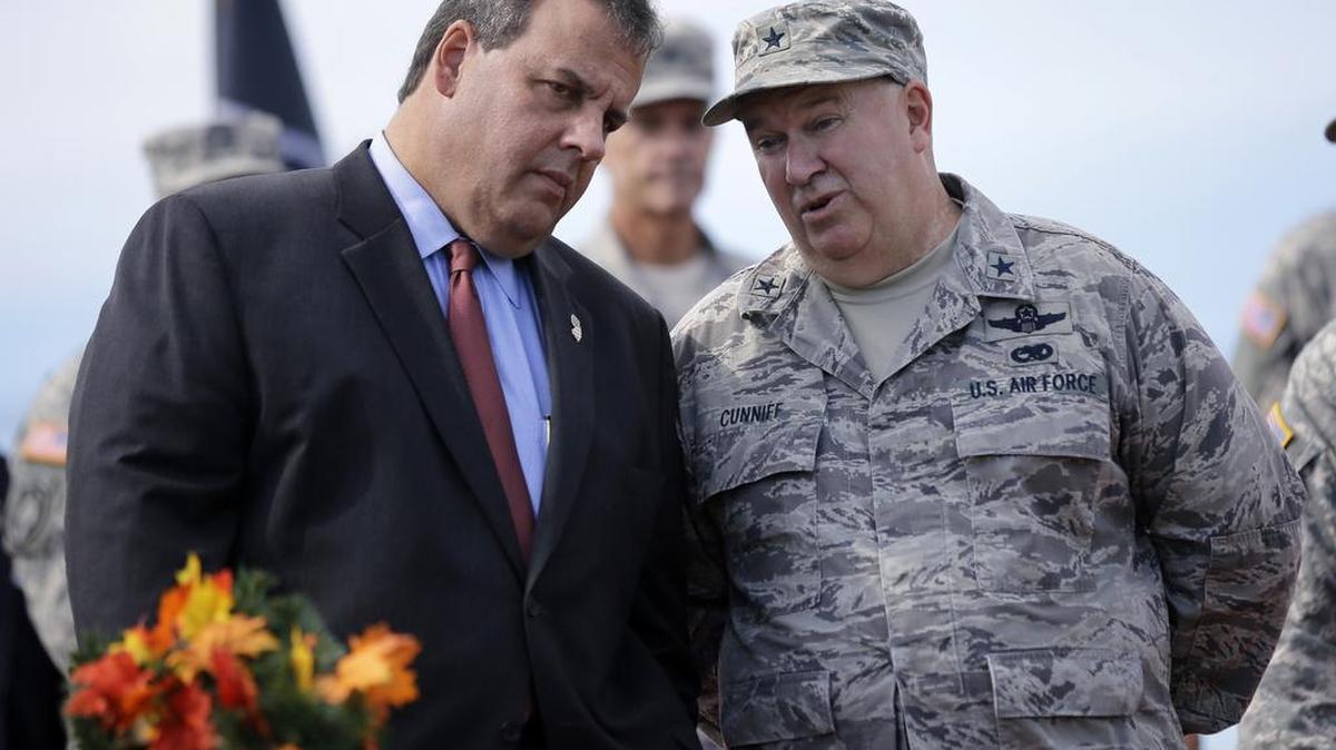 New Jersey Gov. Chris Christie, left, listens to New Jersey Adjutant General Brig. Gen. Michael Cunniff, right, as they review troops during the New Jersey National Guard’s annual Military Review in Sea Girt, N.J.