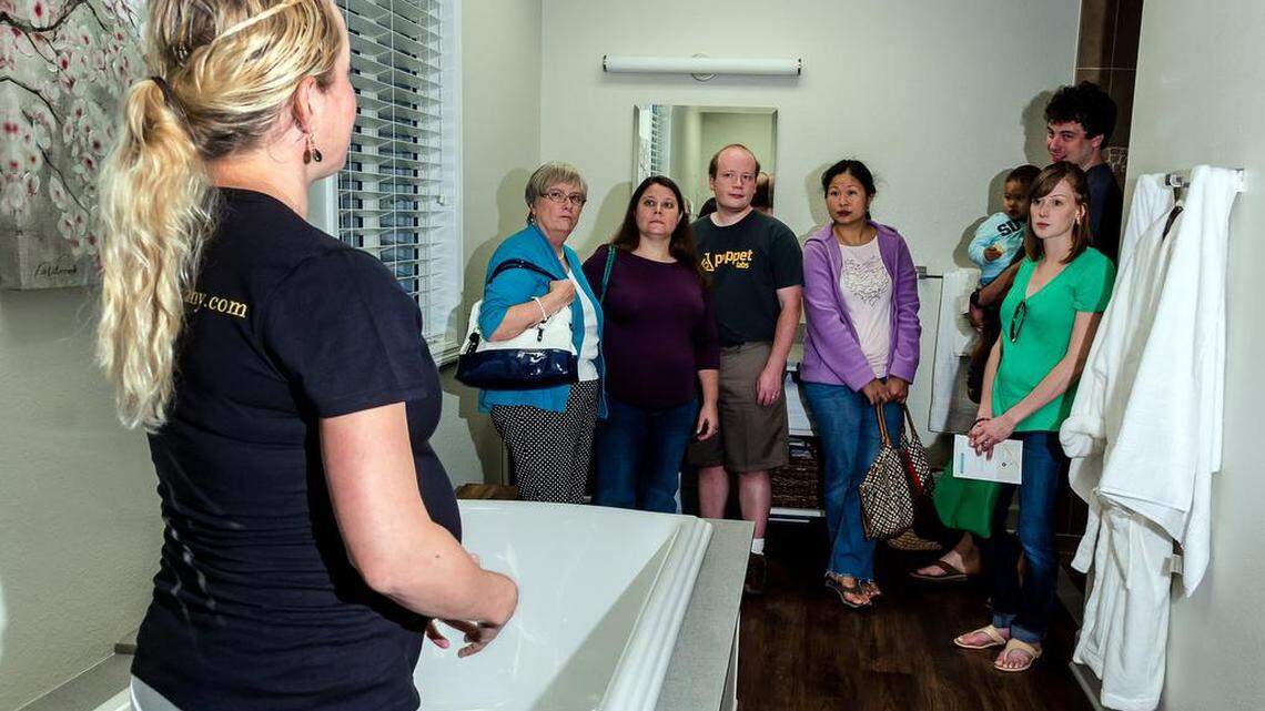 A Baby+Co. employee shows visitors one of three birthing tubs at the Cary, North Carolina, facility during an open house in 2014.