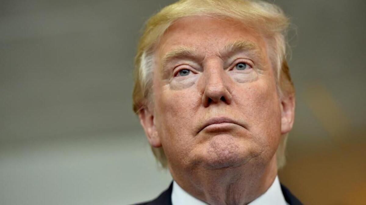 
Republican presidential candidate Donald Trump listens during a news conference after speaking at the TD Convention Center, in Greenville, S.C., on Thursday. Trump has called for mass deportation of millions of immigrants living in the U.S. illegally, as well as their American-born children.
