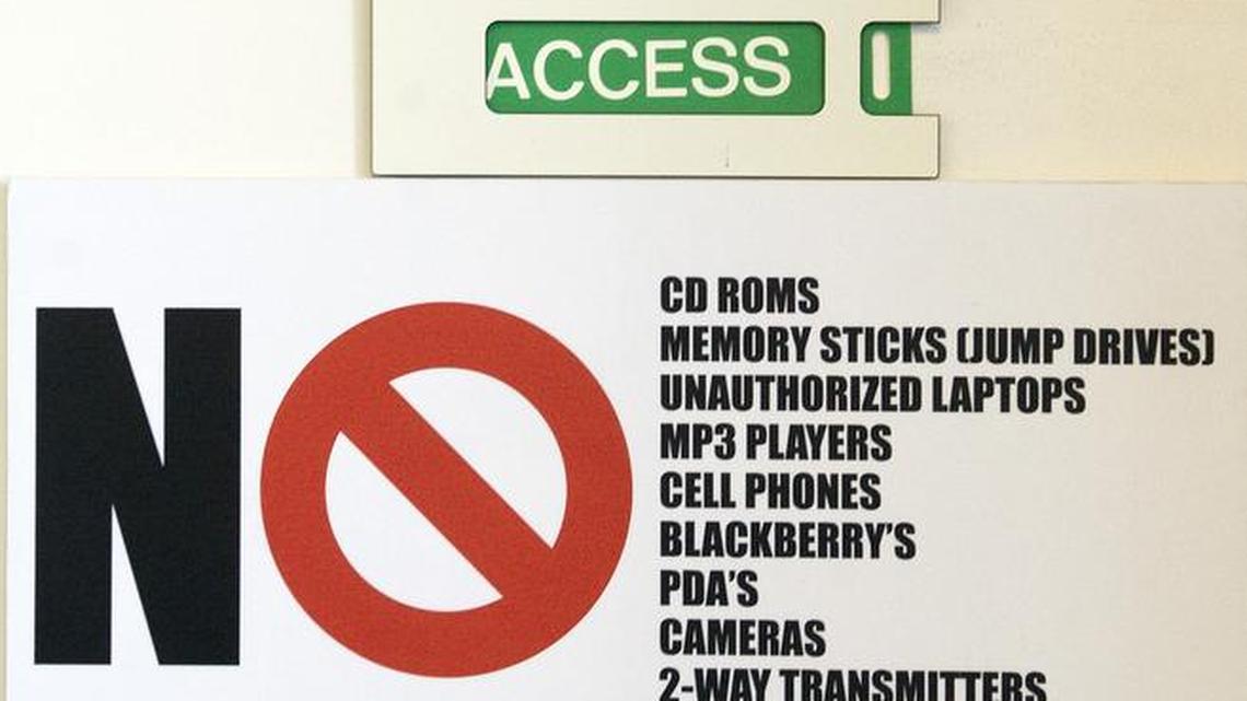 A sign on a door shows prohibited articles at the Industrial Control Systems Cyber Emergency Response Team Watch and Warning Center during the first tour of the government’s secretive cyber defense lab at the Idaho National Laboratory on Sept. 29, 2011, in Idaho Falls, Idaho.