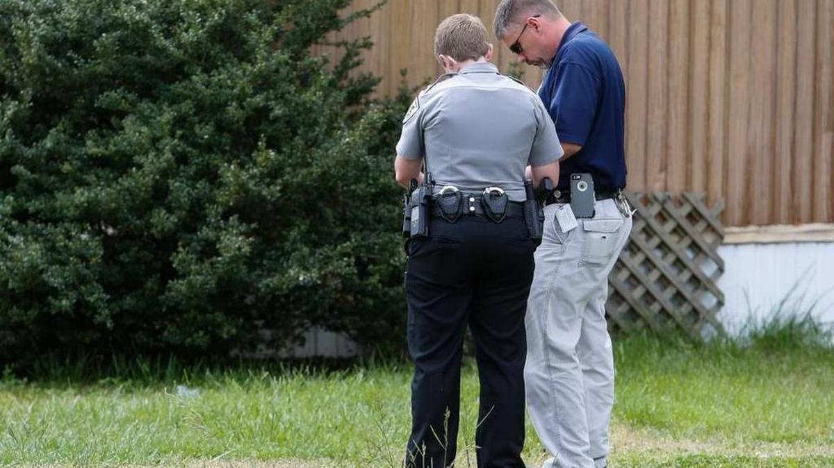 Officers confer after talking with one of the boys who reported an attempted abduction. Police soon discovered the boys made up the story in order to skip school.