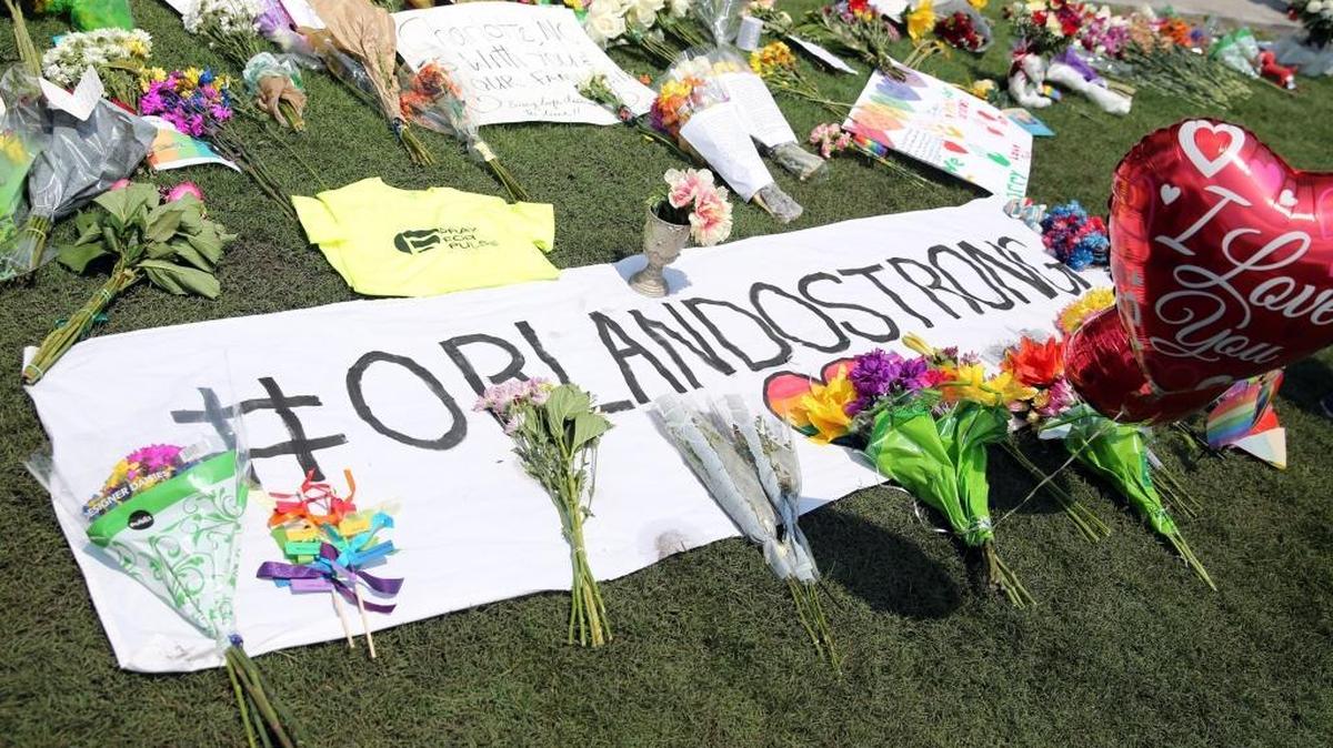 A growing memorial of flowers line the grass in the Seneff Arts Plaza in downtown Orlando, to honor those killed at Pulse nightclub in Orlando.