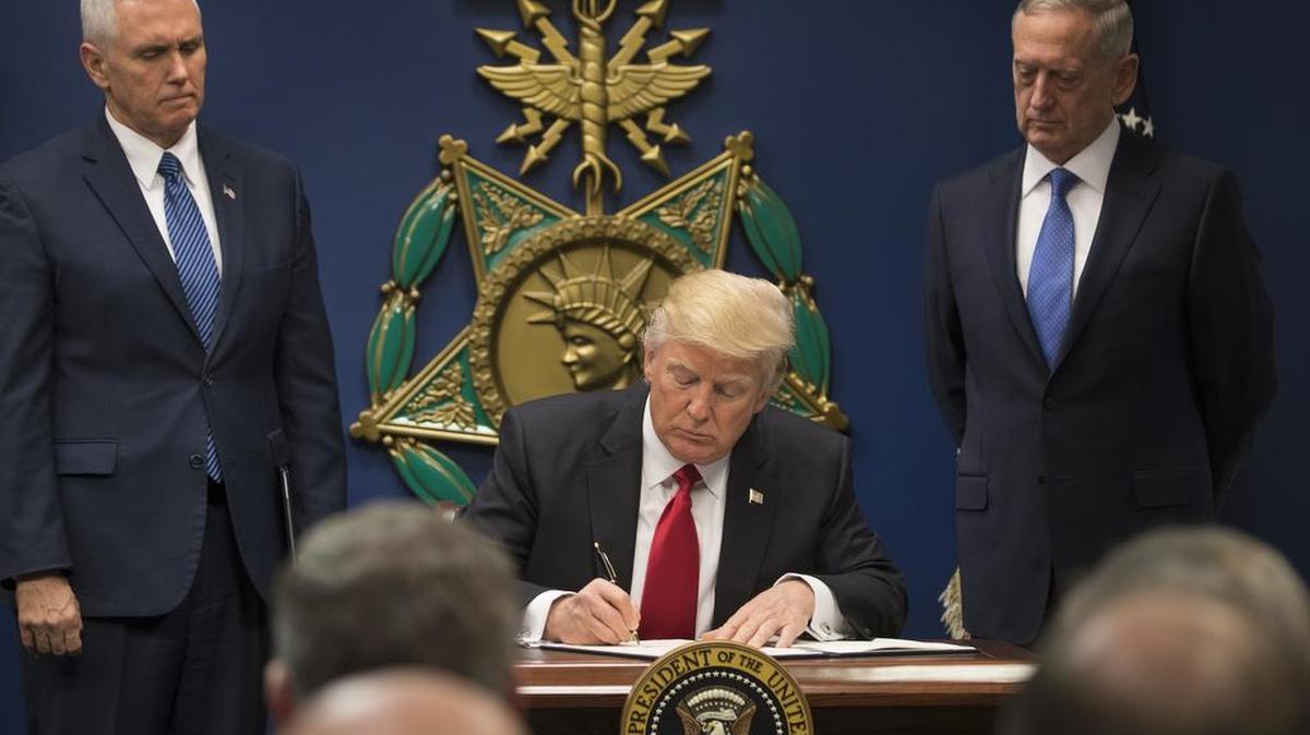 President Donald Trump signs an executive order on immigration, at the Pentagon in Arlington, Va., Jan. 27, 2017.