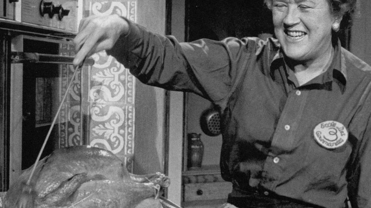 Julia Child bastes a turkey made the way she preferred: roasted whole, unstuffed.