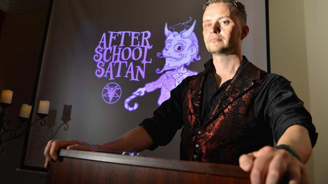 Doug Mesner, a.k.a. Lucien Greaves, with the logo for the Satanic Temple's proposed After School Satan Club.