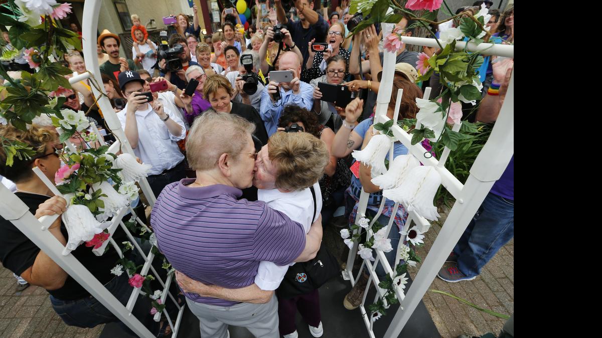 
Ann Sorrell, 78, left, and Marge Eide, 77, of Ann Arbor, a couple for 43 years, embrace after exchanging vows in Ann Arbor, Mich., following a ruling by the US Supreme Court that struck down bans on same sex marriage nation wide Friday, June 26, 2015. 
