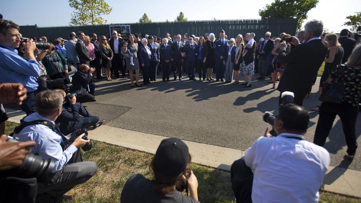 Members of the media watch as family and friends of World War II pilot Elaine Danforth Harmon arrive for the burial services Wednesday, Sept. 7, 2016, at Arlington National Cemetery in Arlington, Va.