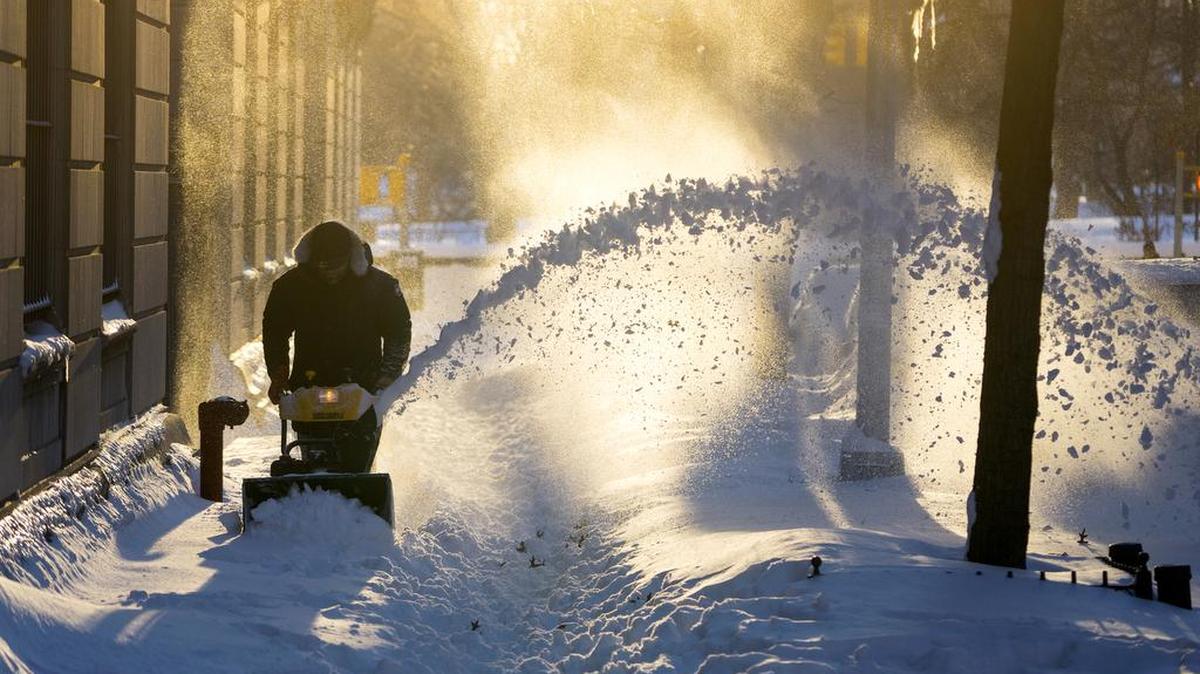Snow is cleared along a street in the Upper West Side neighborhood of New York Sunday, Jan. 24, 2016, in the wake of a storm that dumped heavy snow along the East Coast.