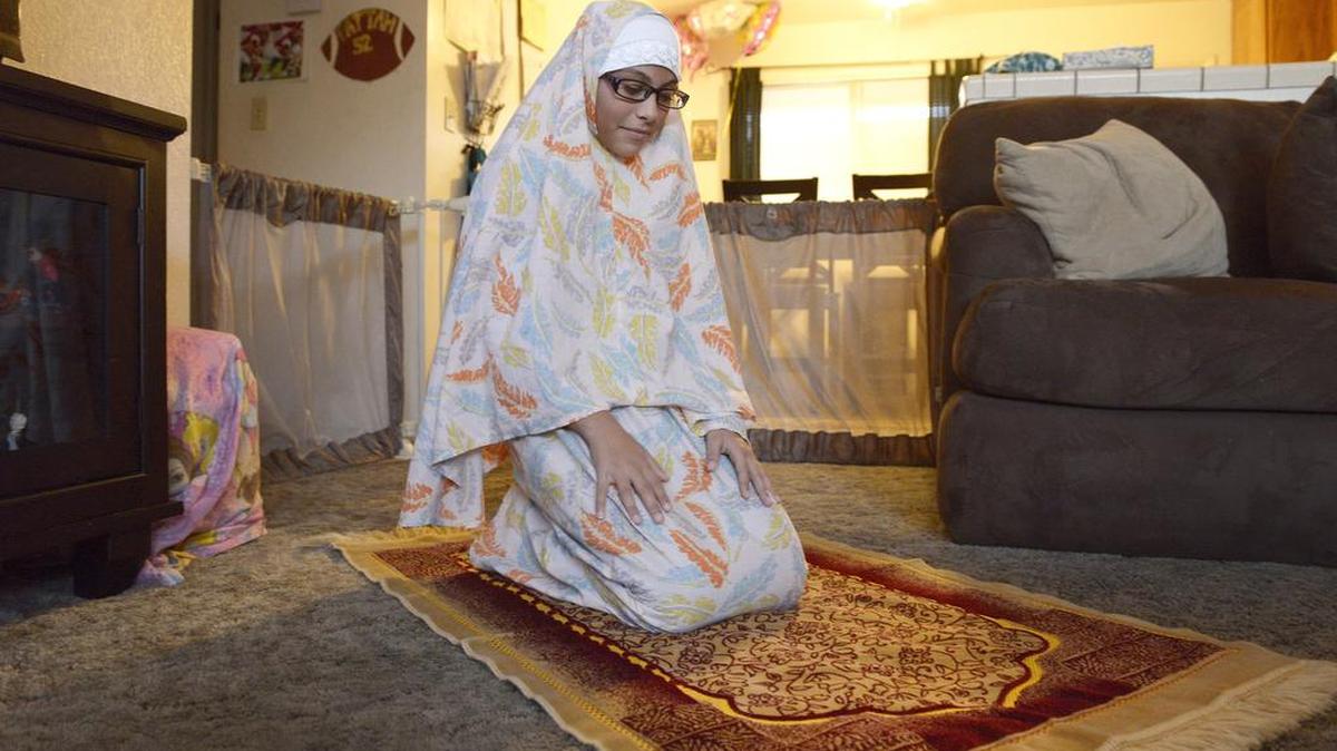 Lulu Abdel Fattah, 10, of Kingsburg prays as part of her Muslim faith, at her home Monday, Dec. 14, 2015. Lulu began wearing a traditional Muslim hijab to school on Monday and was teased by teachers for it.