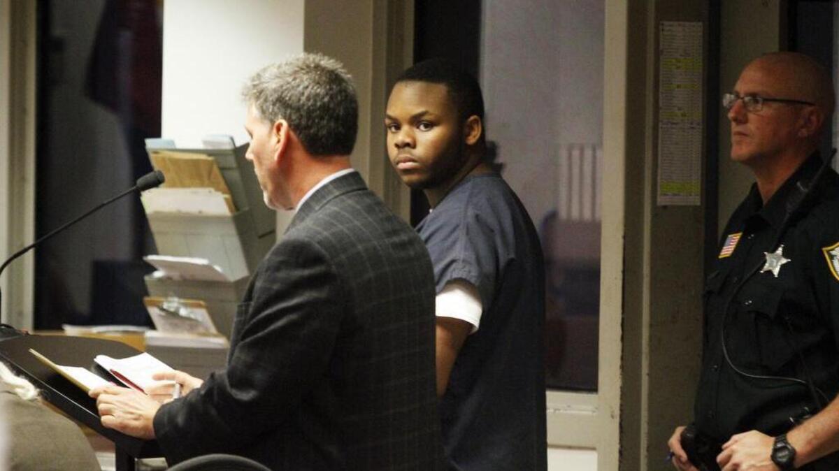 Malachi Love-Robinson, 18, of West Palm Beach, Fla., looks over at his grandfather during his first-appearance court hearing Wednesday, March 2, 2016, at the Palm Beach County Court Criminal Justice Complex in West Palm Beach.