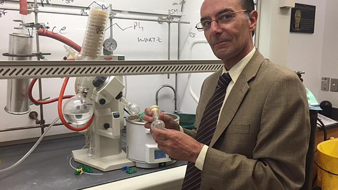 Andrew Coop, associate dean of academic affairs and professor at the University of Maryland School of Pharmacy, holds a small container of UMB425, a synthetic opioid painkiller he developed with Alex MacKerell, director of UM's Computer-Aided Drug Design Center. Unlike other prescription opioids, Coop says, the experimental drug will not cause physical dependency.