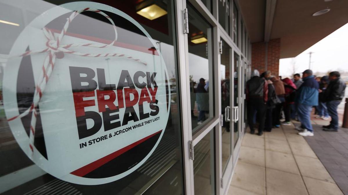 A sign promoting Black Friday specials is displayed in the window of a J.C. Penny in northeast Denver.