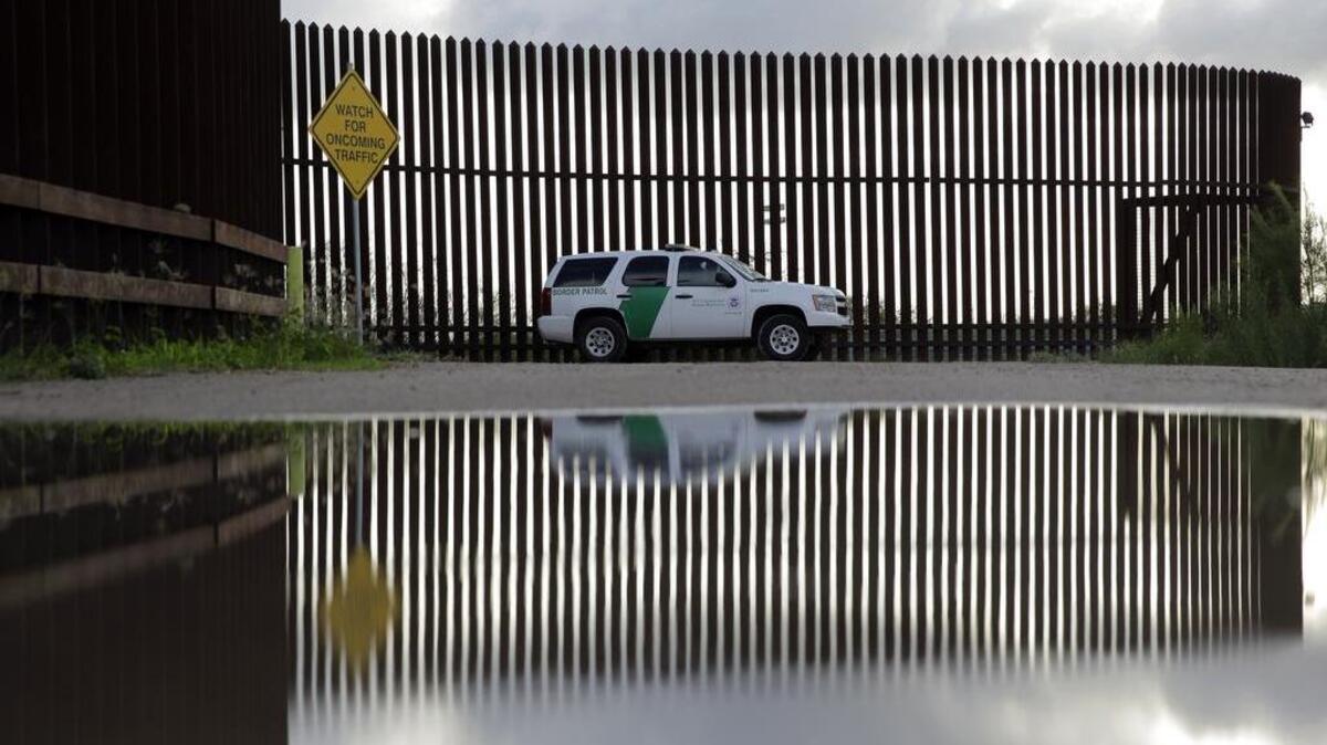 A U.S. Customs and Border Patrol agent drives along the border fence in Hidalgo, Texas, on Sept. 15, 2015.