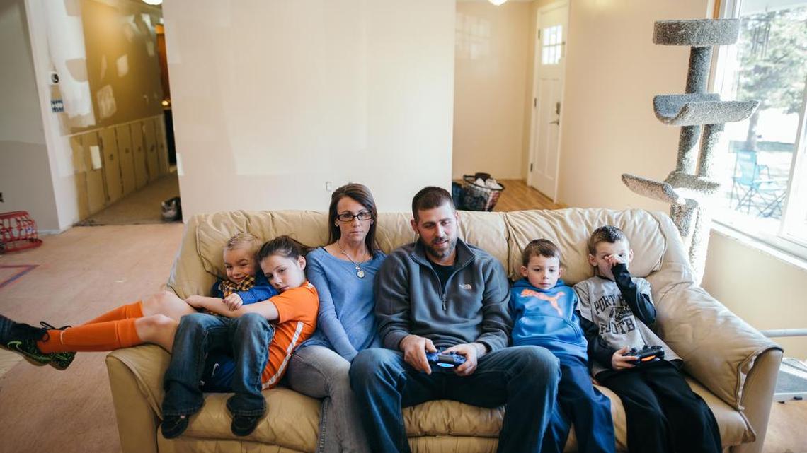 Annette Shattuck and her family sit inside their home in Port Huron, Mich.