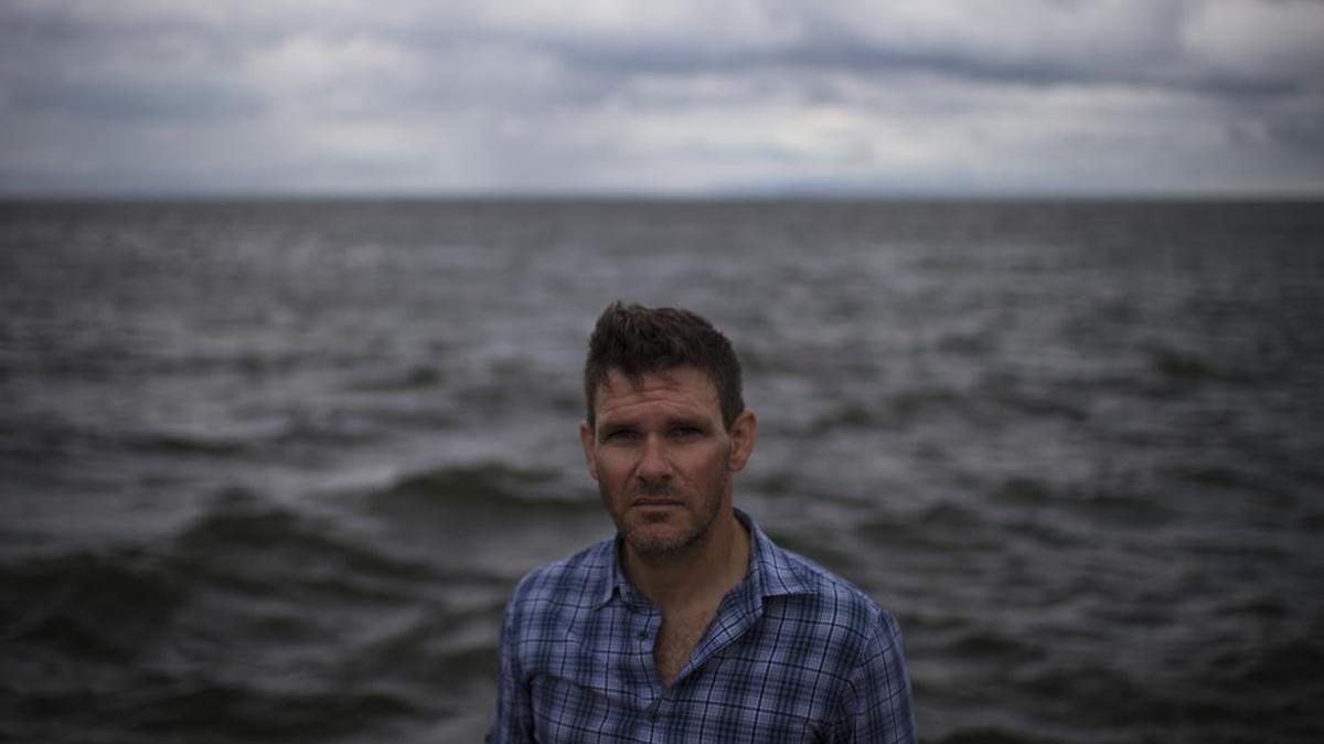 
“I knew it was going to be dangerous, but had no idea I was going to be so alone,” Ken Bellau, a 10th generation New Orleans native, says, here standing by Lake Pontchartrain on Aug. 19, 2015. Bellau saved over 400 people after Hurricane Katrina. 
