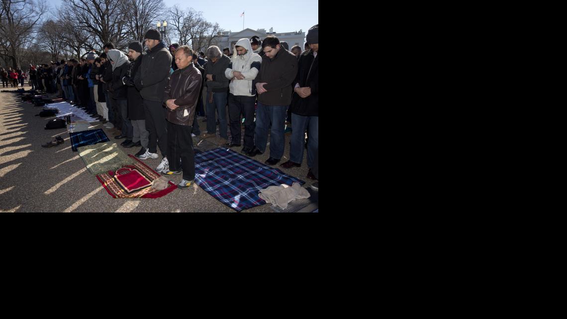
Muslims and others prepare to say the Friday prayers outside the White House in Washington, in the wake of the murder of three young North Carolina Muslims, Friday, Feb. 13, 2015. The gathering was in memory of the Chapel Hill shooting victims, and to press federal authorities for a hate crime investigation.
