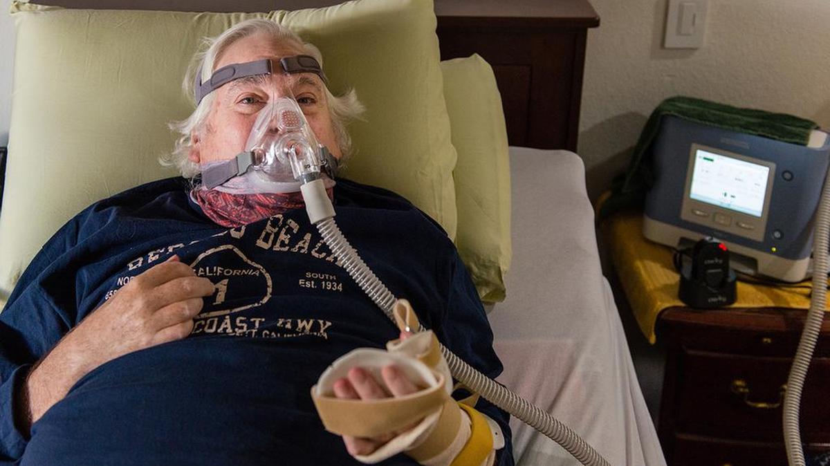 Colin Campbell needs to use a trilogy ventilator to help him breathe and depends on a home health worker to put it on.